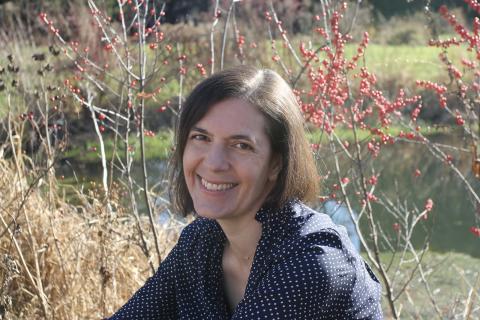 Faculty member Rebecca Olander smiling outdoors.