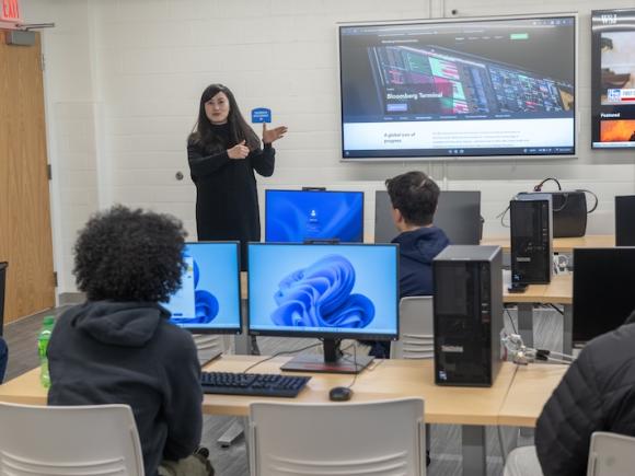 The new Finance & Data Analytics Lab in Parenzo Hall at Westfield State University, Jan 2025. A professor presents during class in front of a television while students watch and listen.