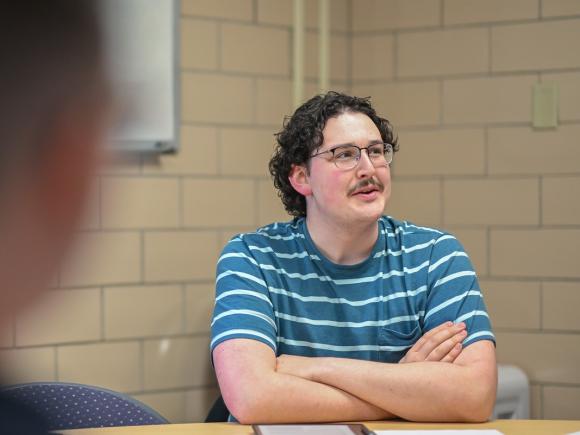 Counseling student attentively listening during a classroom lecture.
