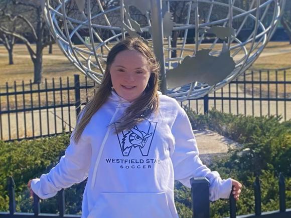 Katelyn Flaherty standing in front of campus globe (photo credit Maipse).