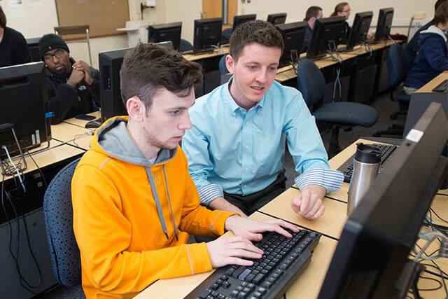 Multiple students working in a computer lab.