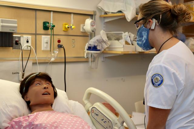 Student in nursing simulation lab working with a manikin.