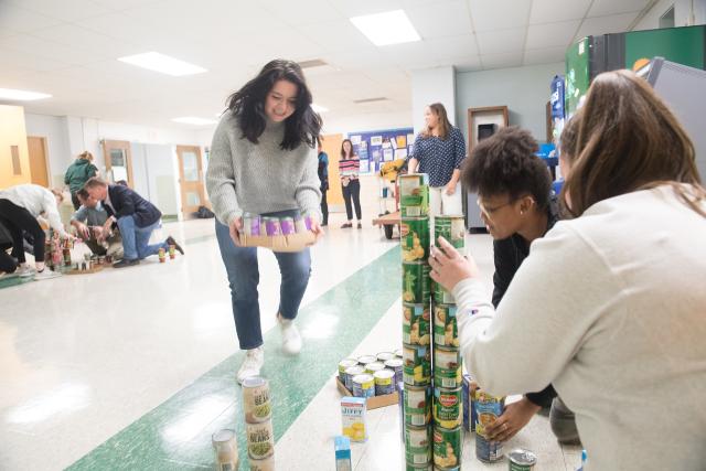 Students working on Tower Challenge with canned foods.
