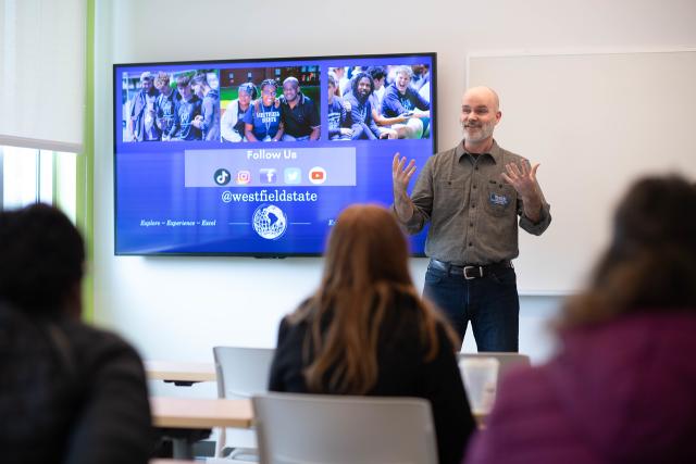 Faculty member giving a presentation in front of students.
