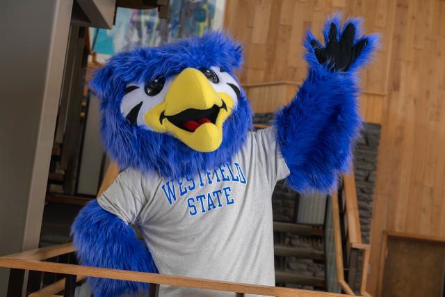 Nestor the mascot waving hello.