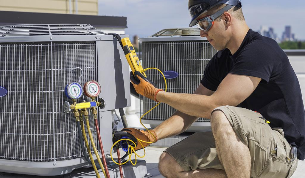 man working on central air unit
